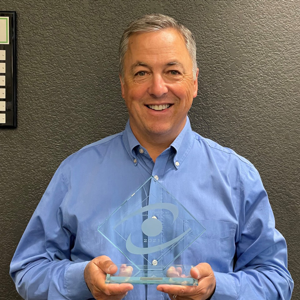 Tim Hausbeck holding Michigan 50 Companies to Watch Award